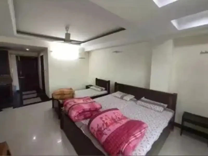 Comfortable 3 Bed Non-AC Room featuring three clean beds, spacious interior, simple furnishings, natural lighting, and a budget-friendly stay environment ideal for families or groups.